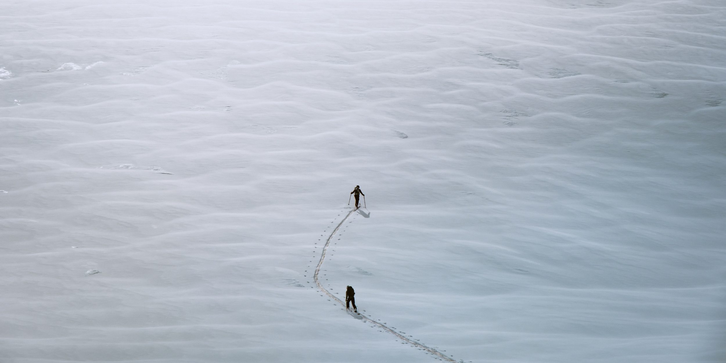 Edging Ice, two figures crossing wind-sculpted ice