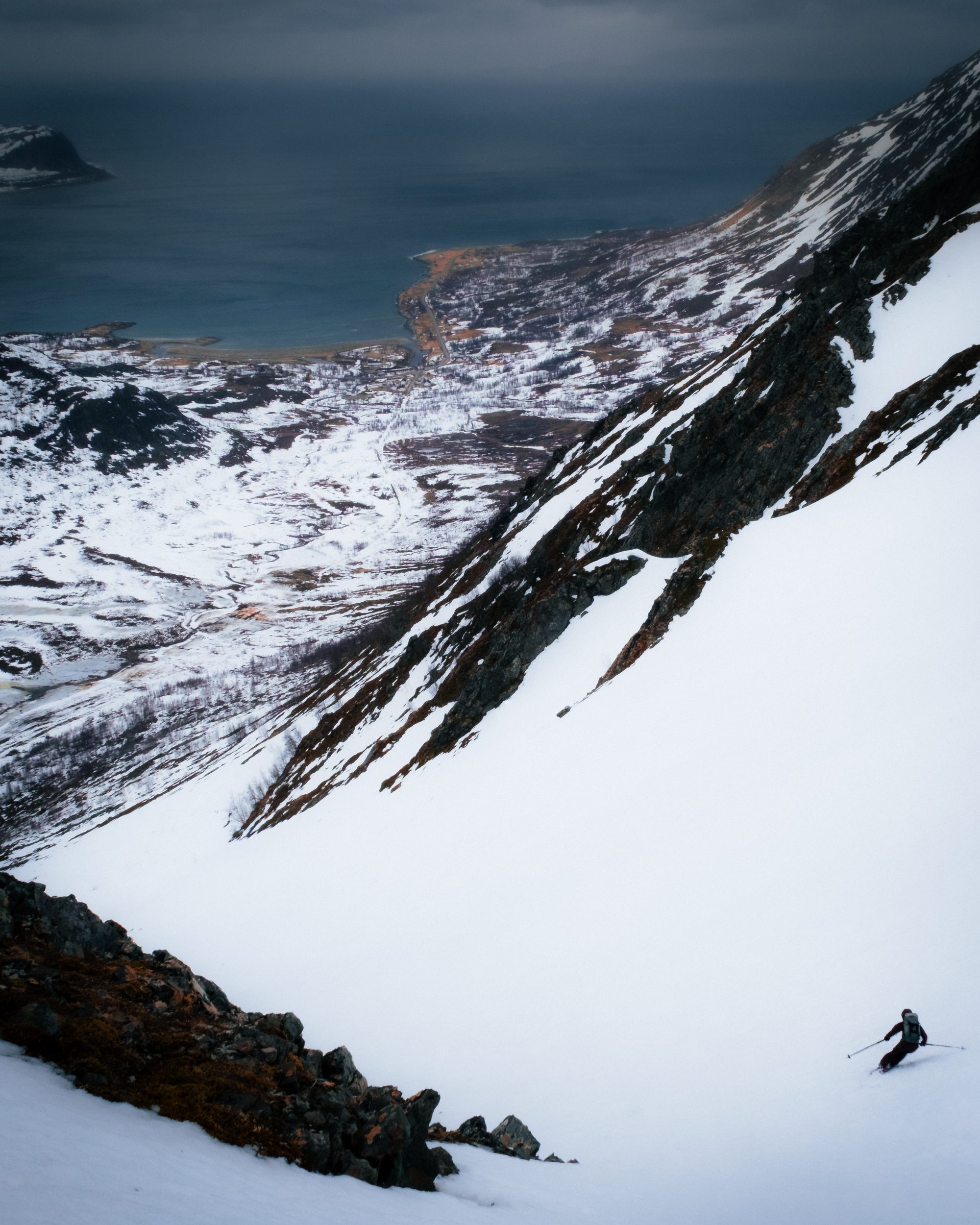 A skier above the fjord village, east of Lyngen