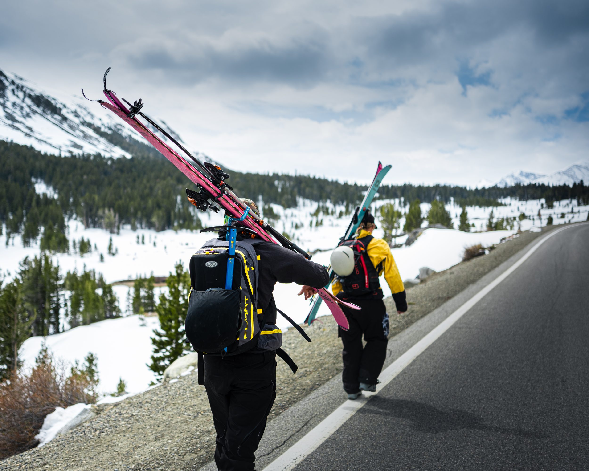 Skiers walking the road shoulder, Eastern Sierra approach